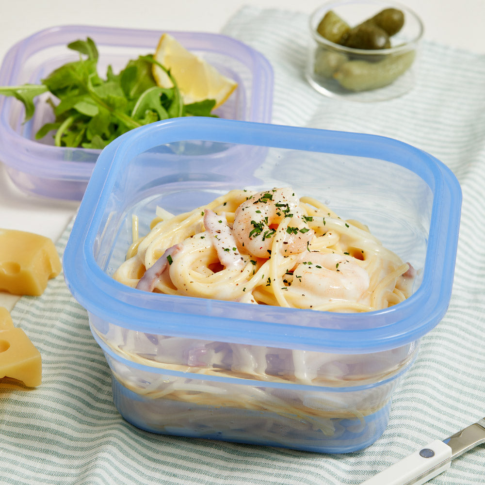PushLock container with pasta, a salad behind it