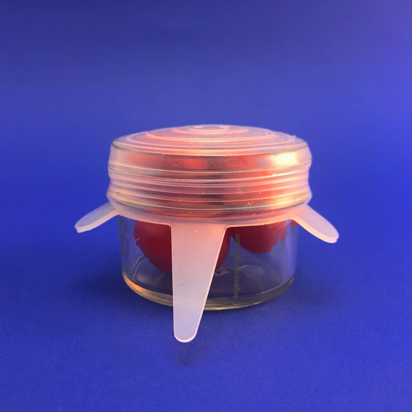 Silicone food wrap stretched over a glass jar