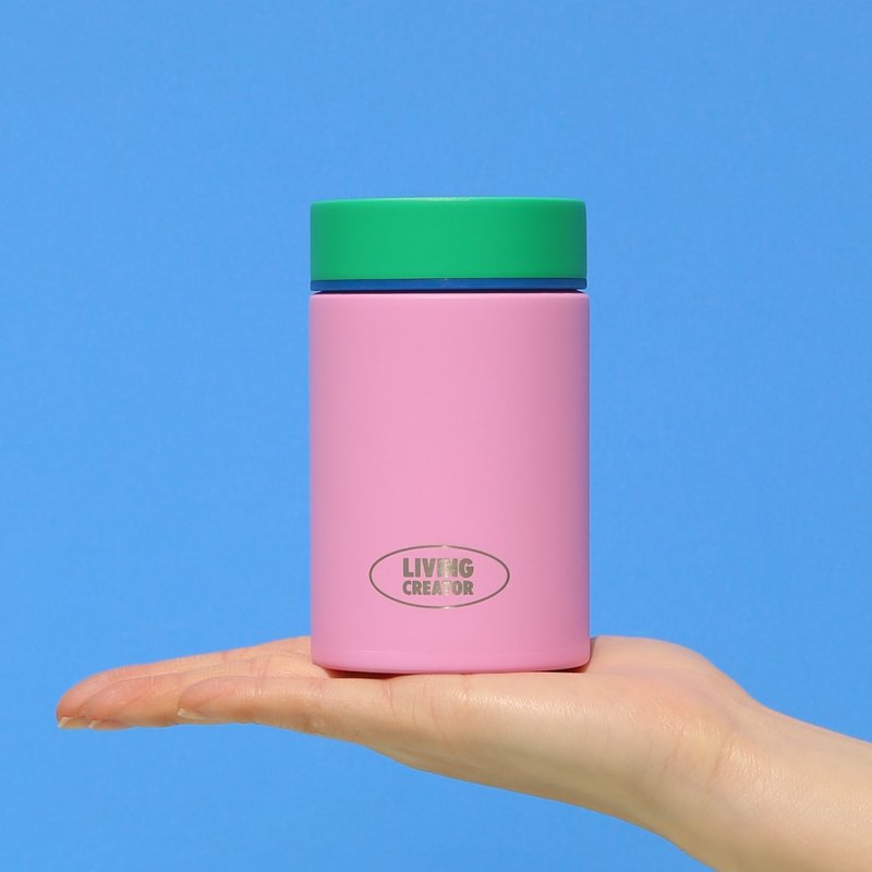 A pink MYTUM held in one hand