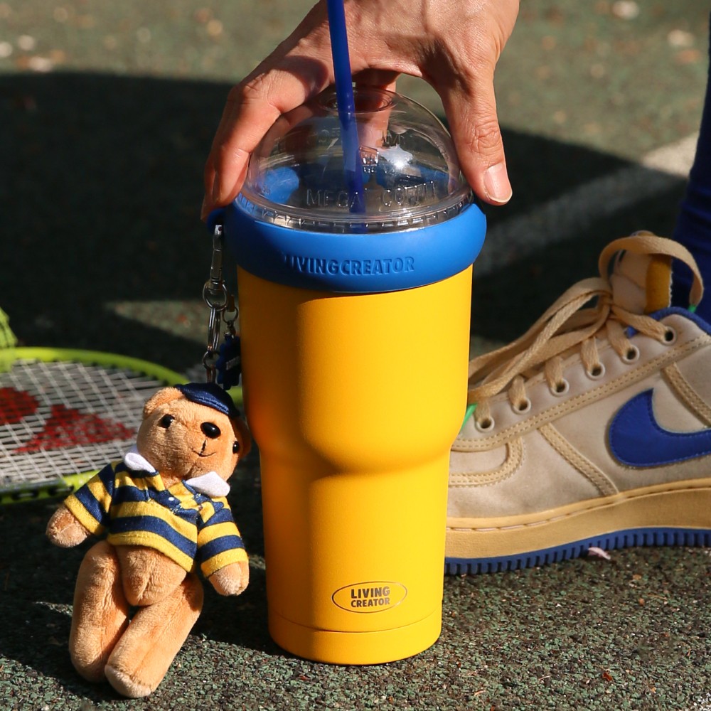 Yellow KEEPER TUM on the court next to sneakers