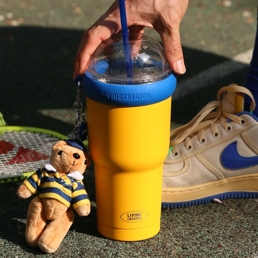 Yellow KEEPER TUM on the court next to sneakers